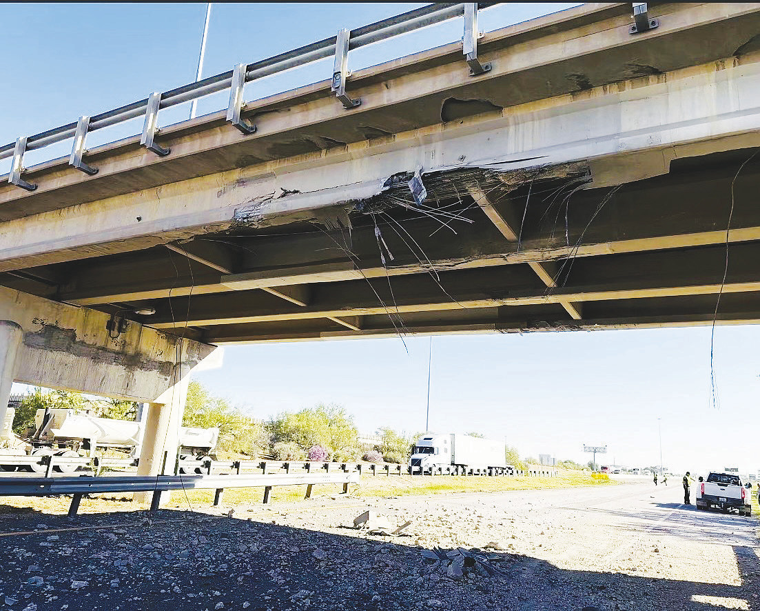 Chunks of concrete and other damage are visible underneath the Loop 250 overpass at I- 20 Tuesday after a commercial vehicle hauling a forklift struck the bridge. Pieces of the damaged bridge were left hanging above the roadway.