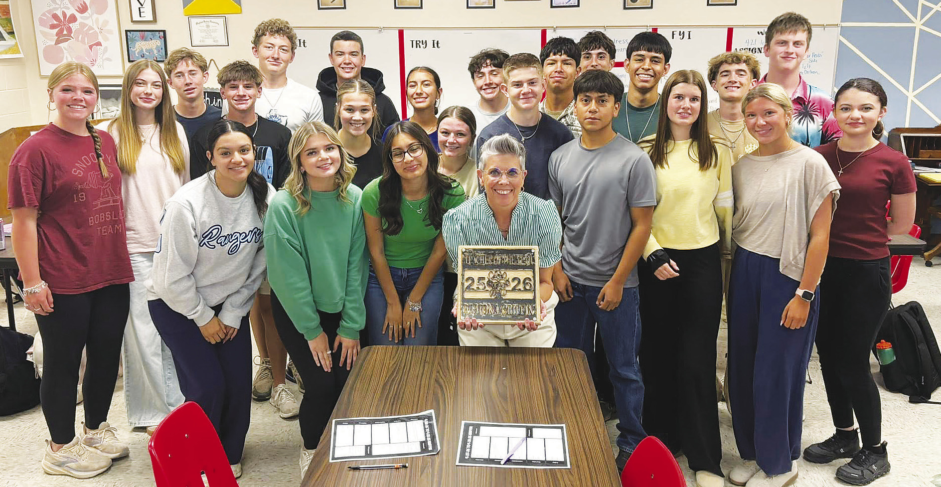Greenwood High School English teacher Ramona Griffin celebrates with students after being named the campus's Teacher of the Year in April. Griffin has since been named Region 18's 2027 Secondary Teacher of the Year, putting her in the running for the statewide title.