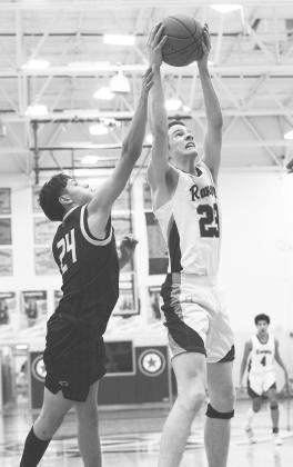 (LEFT) Greenwood Ranger Caden Underwood grabs an offensive rebound during non-district action earlier this season.