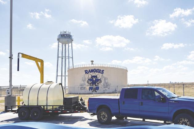 A customer fills a water tank at MCUD’s bulk water station on SCR 1140. The district began selling bulk water in August.