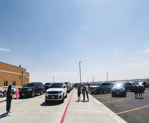 Vehicles line up for afternoon pickup at Greenwood ISD’s new elementary and intermediate schools on South County Road 1110. District leaders say they are continuing to work on ways to improve traffic flow at the new campuses.