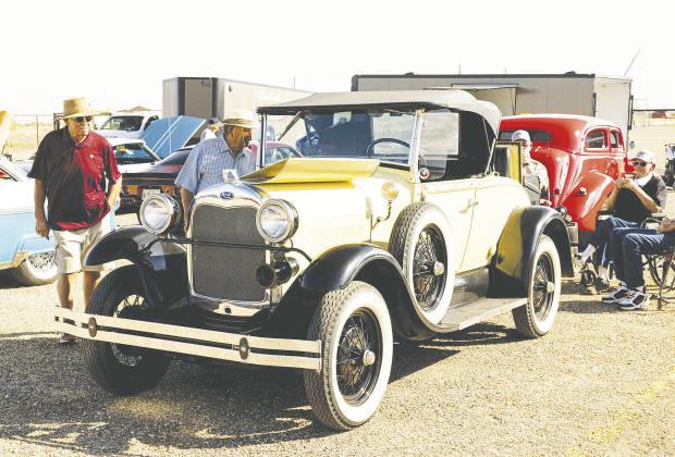 Folks admiring classic cars at a past Redneck Roundup Car &amp; Truck Show in Stanton. The show returns Oct. 11 for its fifth year and is expected to bring in about 400 cars and trucks. Proceeds benefit Gifts of Hope, which supports cancer patients and their families across the Permian Basin.