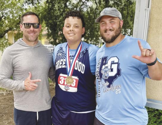 Greenwood state track athlete Tristan Wilson takes a picture with Brien Burchett and Ryan Cox with his newly earned 2025 State Bronze Medal.