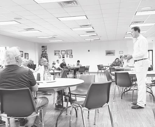 Rep. August Pfluger has a conversation with Nestor Hernandez about the sate of the VA Hospital during a Town Hall Meeting in Stanton on Monday.
