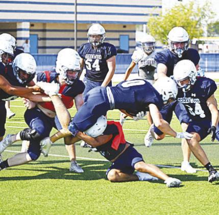 Greenwoods offense and defense go to work during intra-squad scrimmage. by Sam Cravey