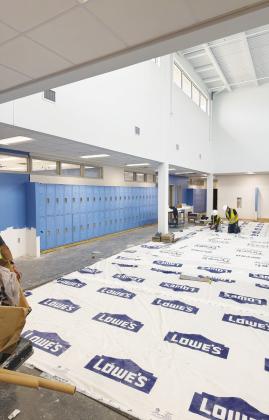 Two construction workers inside one of Greenwood ISD’s new campuses as crews continue preparing the buildings for the start of the 2026-27 school year in August.
