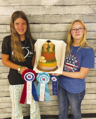 GHS Sophomores Kyleigh Medley and Kylie Redfern with their Wild Wild West-themed cake that earned top awards at the Permian Basin Fair.