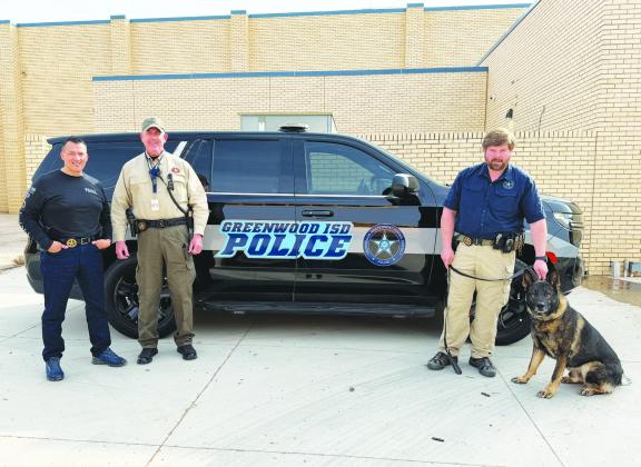 Greenwood ISD police officers stand with their K-9 unit. The district is hiring an officer to replace one who left last month.