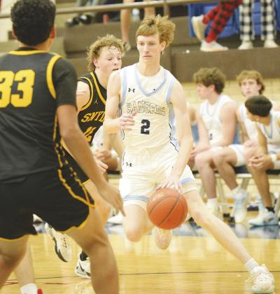 Greenwood’s Ty Presley dribbles past a Snyder defender before pulling up for a 10’ jumper earlier this season. Greenwood will Andrews this Friday.
