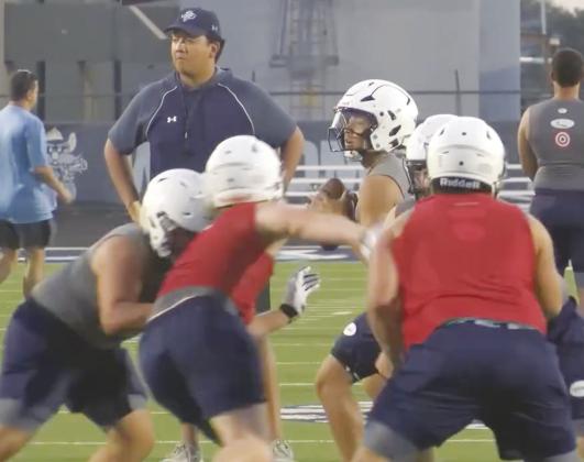 Greenwood senior quarterback Lincoln Madrid runs the offense during the first week of football practice.