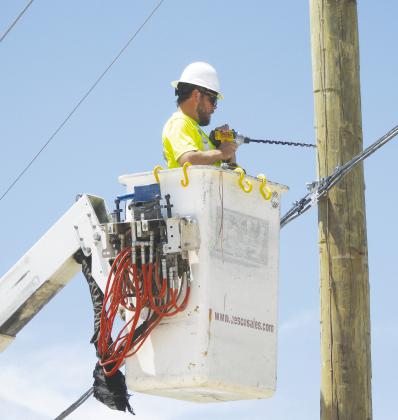 Electrical crews spent the better part of Tuesday afternoon fixing downed powerlines after a tanker truck took down several poles. See story this page.