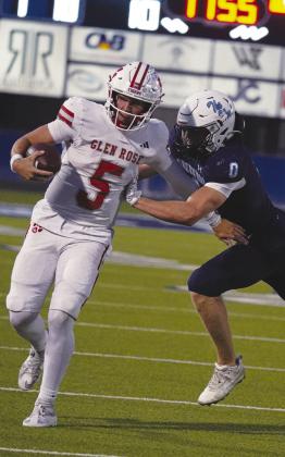 Greenwood senior Reece Watzl delivers a hard shove to force the Glen Rose quarterback out of bounds during Friday night’s matchup. photo by Graycee Underhill