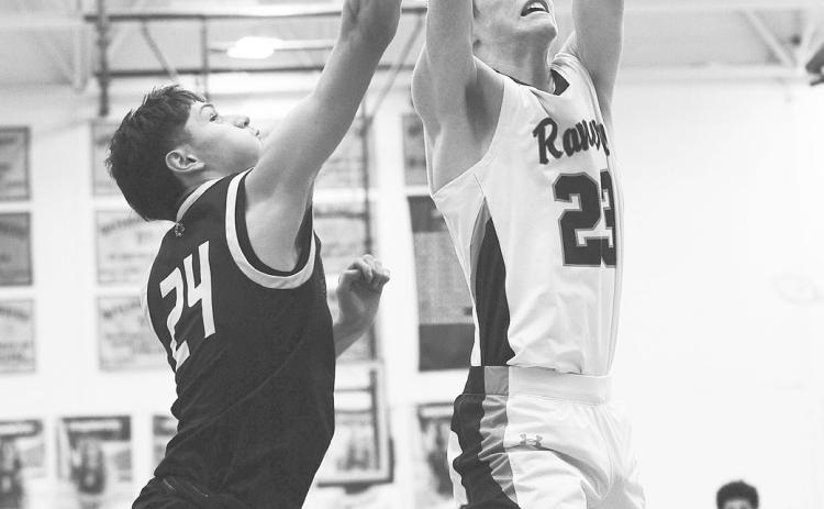 (LEFT) Greenwood Ranger Caden Underwood grabs an offensive rebound during non-district action earlier this season.