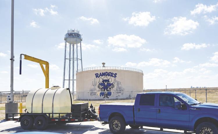 A customer fills a water tank at MCUD’s bulk water station on SCR 1140. The district began selling bulk water in August.