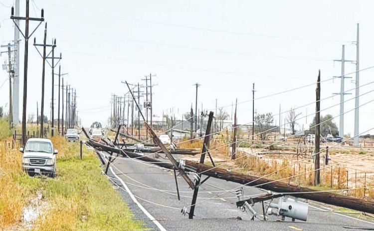 A downed power line blocks South County Road 1150 following heavy thunderstorms Thursday that brought flooding and storm damage to Greenwood. The Greenwood Volunteer Fire Department responded to multiple reports of downed power lines and trees during the storm.