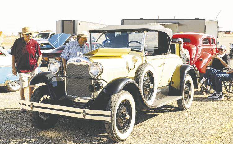 Folks admiring classic cars at a past Redneck Roundup Car &amp; Truck Show in Stanton. The show returns Oct. 11 for its fifth year and is expected to bring in about 400 cars and trucks. Proceeds benefit Gifts of Hope, which supports cancer patients and their families across the Permian Basin.