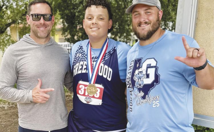 Greenwood state track athlete Tristan Wilson takes a picture with Brien Burchett and Ryan Cox with his newly earned 2025 State Bronze Medal.