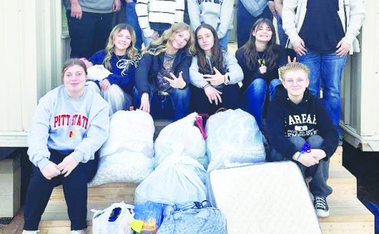 Greenwood High School FFA students pose after collecting towels, blankets, sheets and dog bedding ahead of the winter storm to support Fix West Texas in their efforts to keep stray dogs warm. The nonprofit organization runs a foster and adoption programs for strays and provides low-cost spay and neuter services for any pet owner in West Texas.