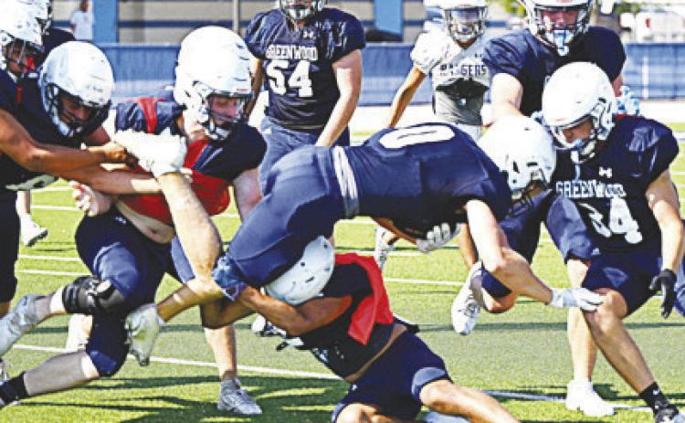 Greenwoods offense and defense go to work during intra-squad scrimmage. by Sam Cravey