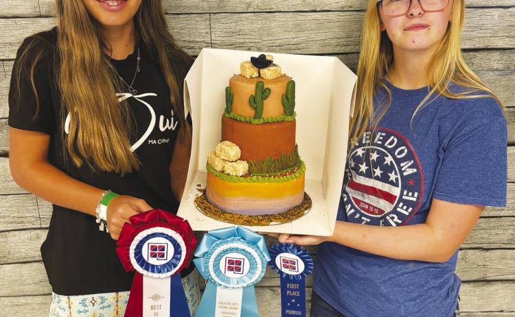 GHS Sophomores Kyleigh Medley and Kylie Redfern with their Wild Wild West-themed cake that earned top awards at the Permian Basin Fair.