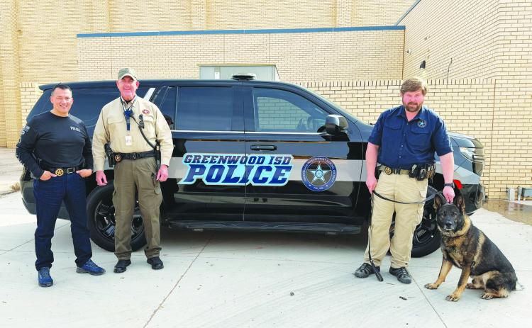 Greenwood ISD police officers stand with their K-9 unit. The district is hiring an officer to replace one who left last month.
