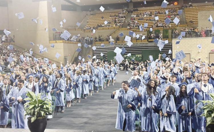 Greenwood High School graduates celebrate the end of one chapter and the start of another as caps fly through the air following commencement ceremonies at the Midland College Chaparral Center on Thursday, May 21.