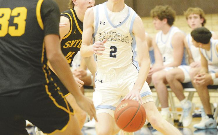 Greenwood’s Ty Presley dribbles past a Snyder defender before pulling up for a 10’ jumper earlier this season. Greenwood will Andrews this Friday.