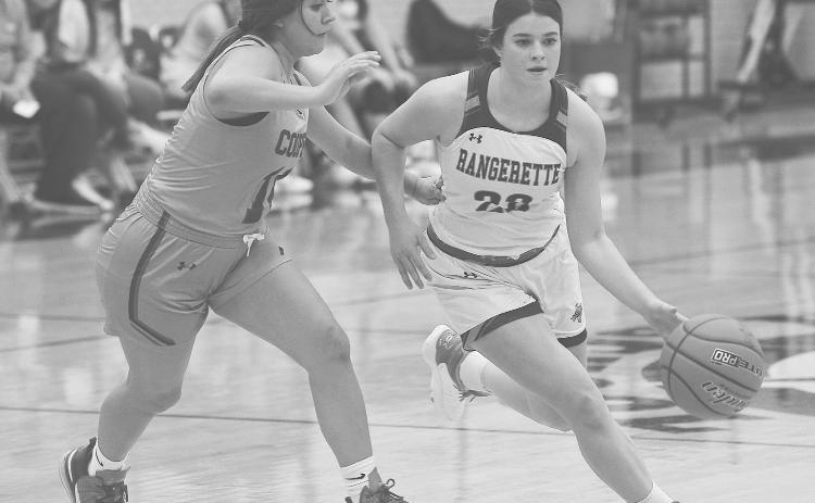 Greenwood guard Brinkley Smith drives around an Abilene Cooper defender during non-district action earlier this season.