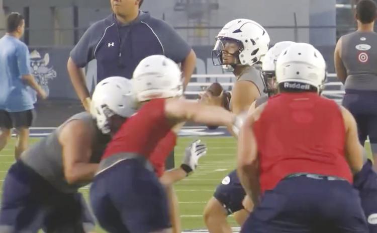 Greenwood senior quarterback Lincoln Madrid runs the offense during the first week of football practice.