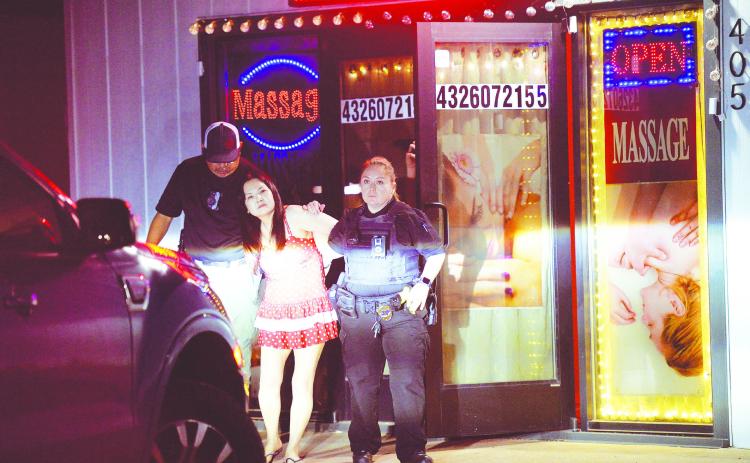 Officers with the Stanton Police Department arrest Guijie Han for prostituion at her place of business on Apr. 30 in Stanton.
