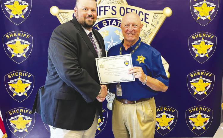 Greenwood graduate Jace Dorner, left, shakes hands with Midland County Sheriff David Criner after being promoted to sergeant in the Midland County Sheriff's Office Criminal Investigations Division.
