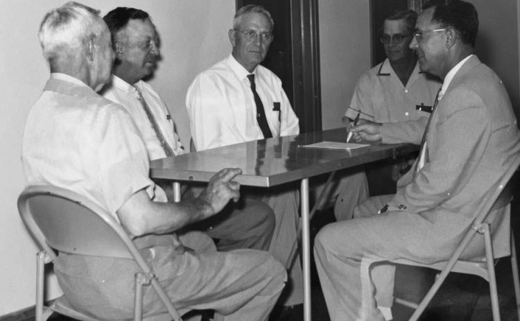 Founding members J.M. King Sr., J.C. Brooks, B.T. Graham and Johnnie Morgan gather around a table with Pastor R.C. Hester for a monthly deacons' meeting at Greenwood Baptist Church in August of 1959.